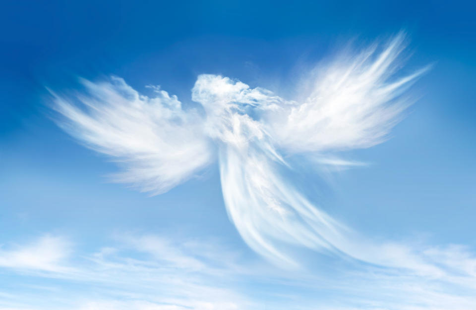 Angel in the clouds on blue sky. (Getty Images)