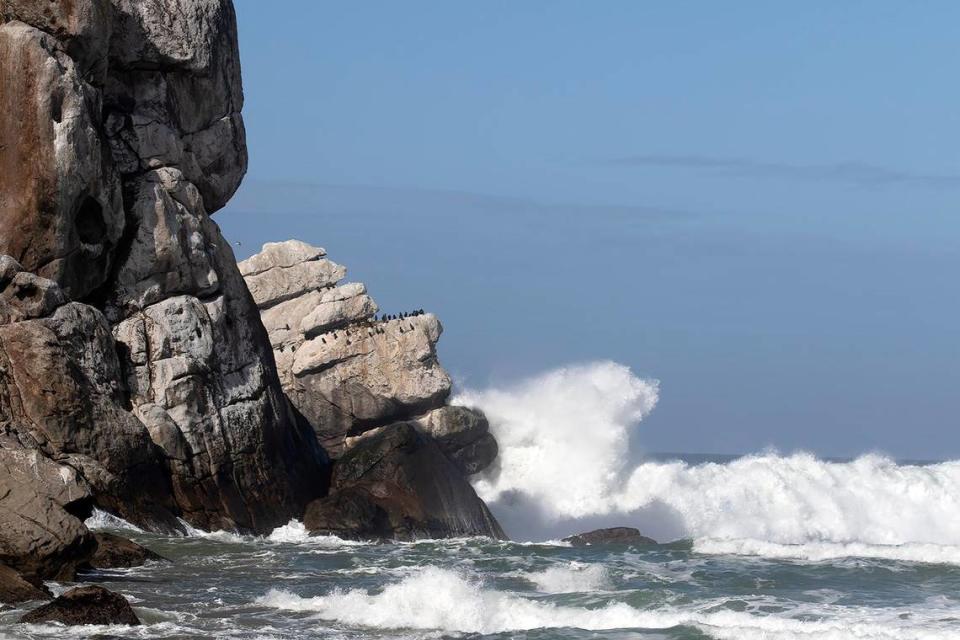 Large waves crash against the “Man in the bathtub” formation at Morro Rock on Monday, Feb. 19, 2024, after a storm slammed San Luis Obispo County on Sunday night, bringing with it rising creeks and rivers and at least one swift water rescue.