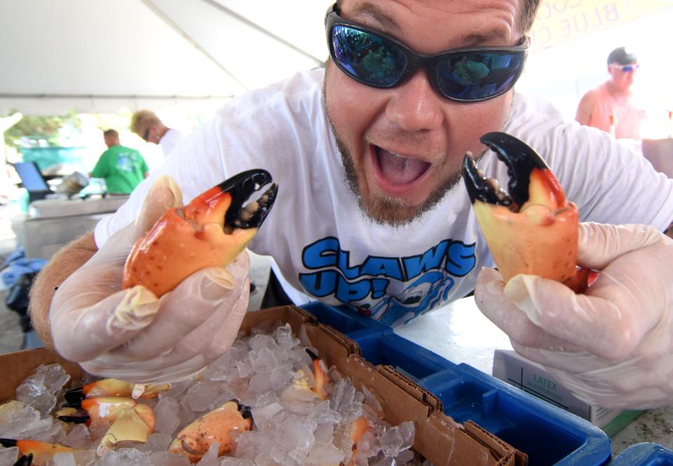 Josh Calvert shows off a couple of stone crab claws during the Cortez Stone Crab & Music Festival held in the Village of Cortez in 2018. The event returns this weekend.