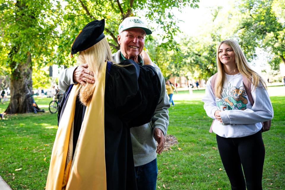 Colorado State University's 16th President Amy Parsons receives a hug from her father after her Fall Address speech on Wednesday.