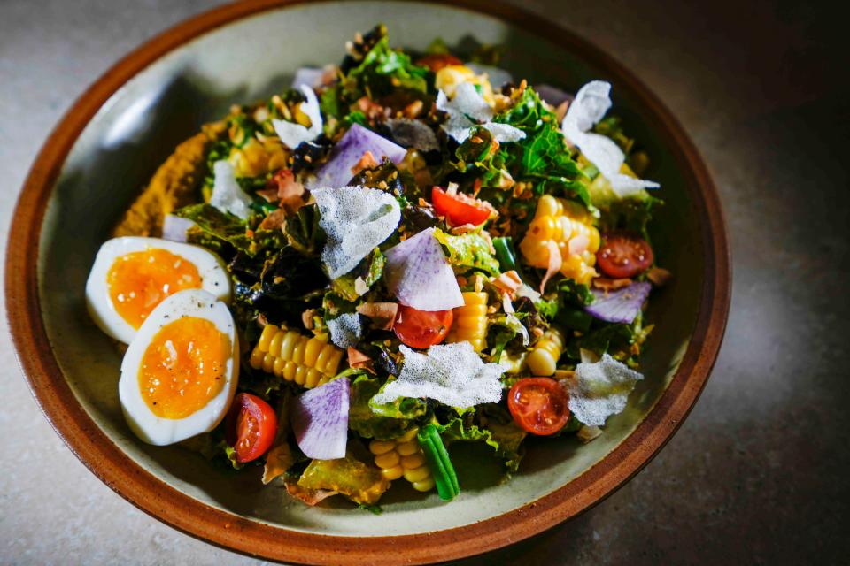 The Gado Gado Cobb Salad at The Wolf on Broadway is Executive Chef Kristen Schwab's take on a classic Indonesian dish, featuring crisp vegetables, hard-cooked egg, rice crisps and a peanut dressing.