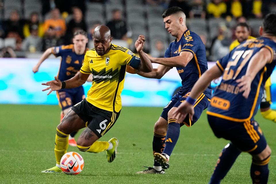 Crew midfielder Darlington Nagbe dribbles around Tigres midfielder Juan Francisco Brunetta. Columbus won the Champions Cup quarterfinal series with a shootout victory on the road.