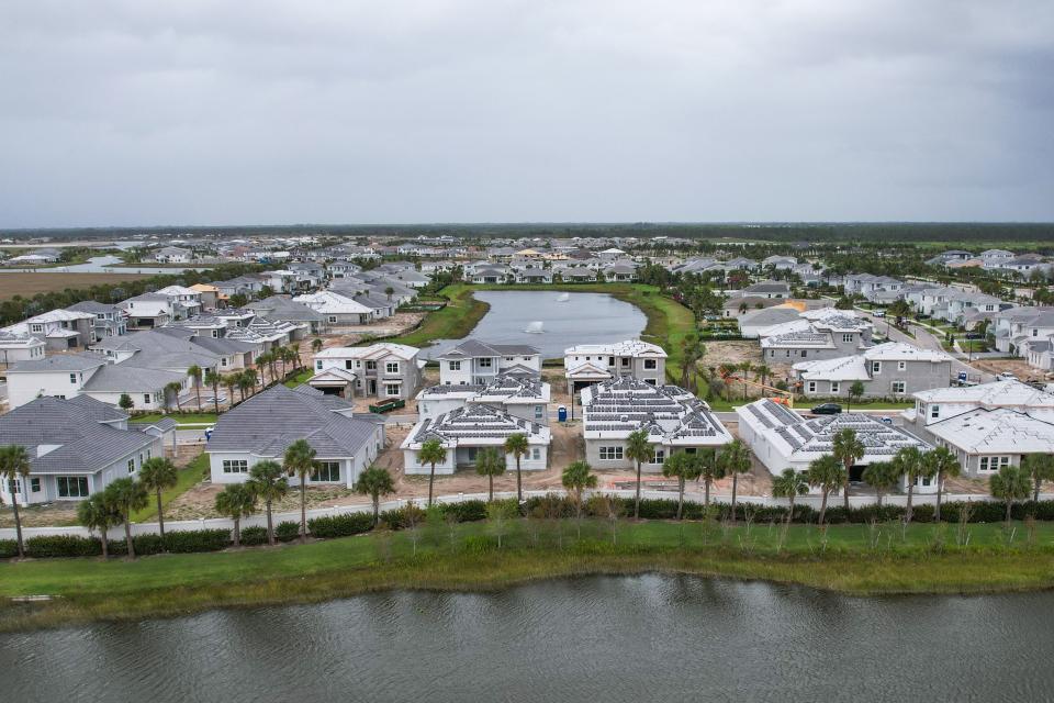Homes under construction at the site of the Avenir community on Tuesday, April 11, in Palm Beach Gardens, Fla.
