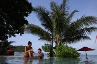 Hotel guests enjoy the beachside pool at the Anantara Rasananda resort.