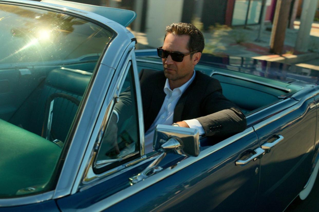 manuel garcia rulfo as mickey haller driving black convertible in the lincoln lawyer season 2, release date july 6