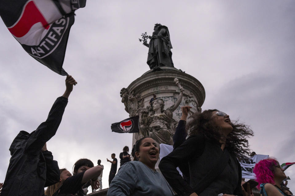 People gather at Republique plaza to protest the far-right National Rally, which came out strongly ahead in first-round legislative elections in Paris, Sunday, June 30, 2024. (AP Photo/Louise Delmotte)