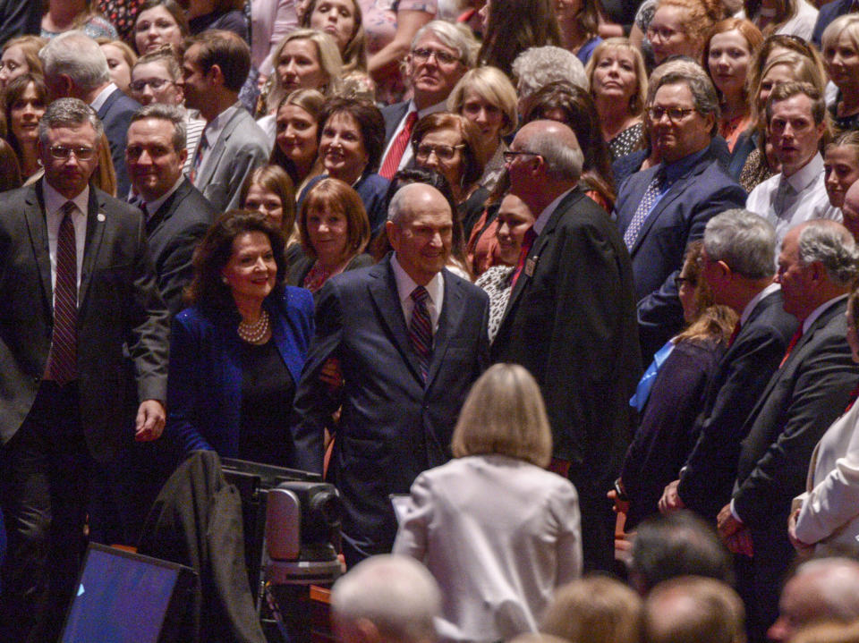 Honored guest, The Church of Jesus Christ of Latter-Day Saints president Russell M. Nelson, center, and his wife Wendy walk to their seats during the gala celebrating Nelson's 95th birthday at The Church of Jesus Christ of Latter-Day Saints Conference Center Friday, Sept. 6, 2019, in Salt Lake City. (Leah Hogsten/The Salt Lake Tribune via AP)