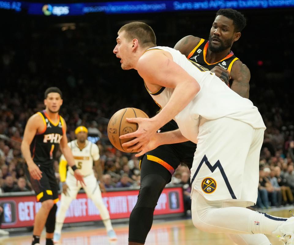Denver Nuggets center Nikola Jokic (15) gets past Phoenix Suns center Deandre Ayton (22) during the fourth quarter of Game 4 of the Western Conference Semifinals at Footprint Center in Phoenix on May 7, 2023.