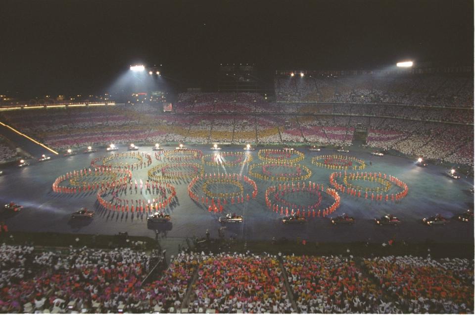 Brightly colored dancers perform during the Opening Ceremony of the 1996 Olympic Games in Atlanta, Georgia.