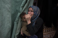 Relatives of Palestinian Naji Zaanin, 25, who was killed in a morning Israeli airstrike, mourn in the family home during his funeral in town of Beit Hanoun, northern Gaza Strip, Wednesday, Oct. 17, 2018. (AP Photo/ Khalil Hamra)