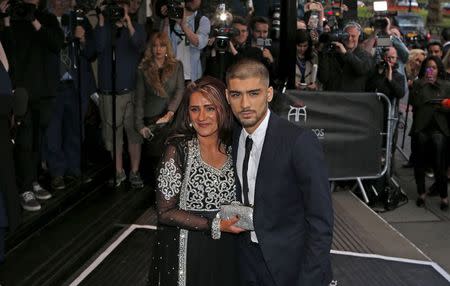 Former One Direction member Zayn Malik (R) and his mother Trisha arrive at the fifth annual Asian Awards in the Grosvenor House Hotel, London April 17, 2015. REUTERS/Cathal McNaughton