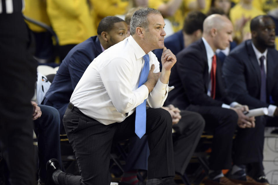 UMass-Lowell head coach Pat Duquette, front, watches his team play against Michigan during the first half of an NCAA college basketball game, Sunday, Dec. 29, 2019, in Ann Arbor, Mich. (AP Photo/Jose Juarez)