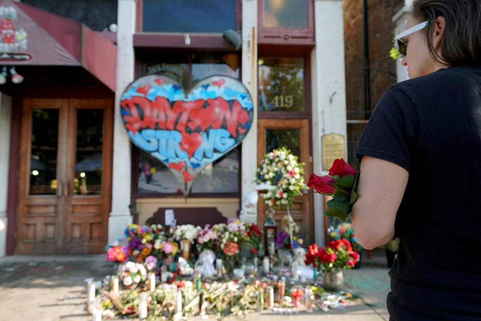 A Oregon District resident stands at a memorial for those killed during Sunday morning's a mass shooting in Dayton, Ohio, U.S. August 7, 2019.  REUTERS/Bryan Woolston     TPX IMAGES OF THE DAY