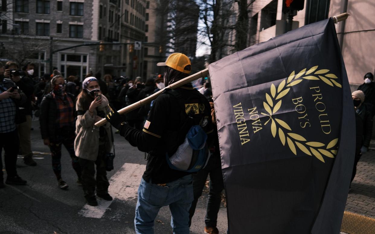 A man carries a "Proud Boys" flag - Eze Amos /Getty Images North America 