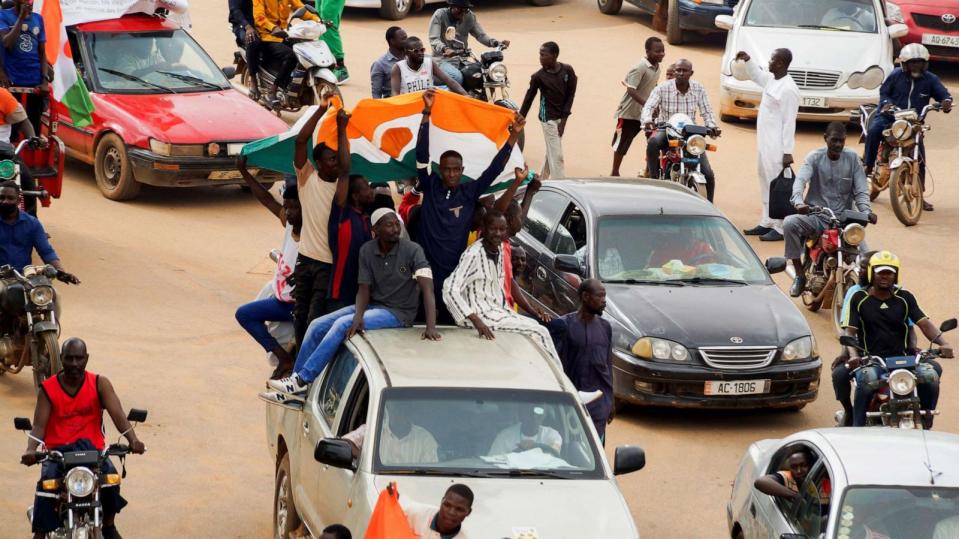 PHOTO: Protestors hold the Niger flag as they arrive to gather in support of the putschist soldiers in the capital Niamey, Niger August 3, 2023. (Balima Boureima/Reuters)