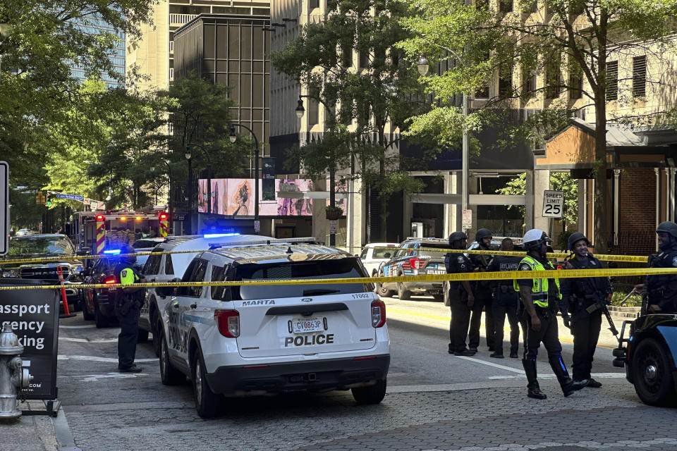 Police respond to the scene of a shooting outside the Peachtree Center complex, Tuesday, June 11, 2024, in downtown Atlanta. (AP Photo/Jeff Amy)