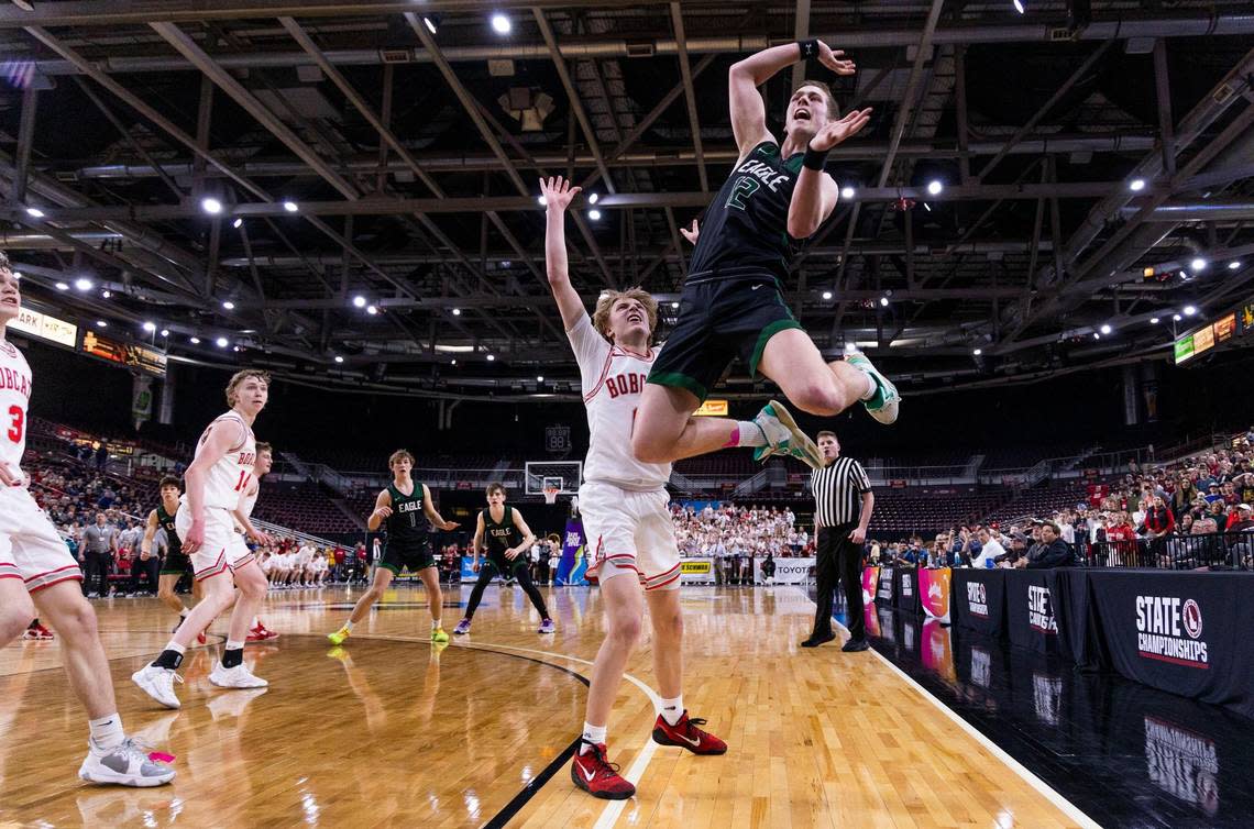 Eagle senior Landon White loses the ball on an inbound pass after Madison’s Nash Humpherys hit his arm late in the fourth quarter Thursday.