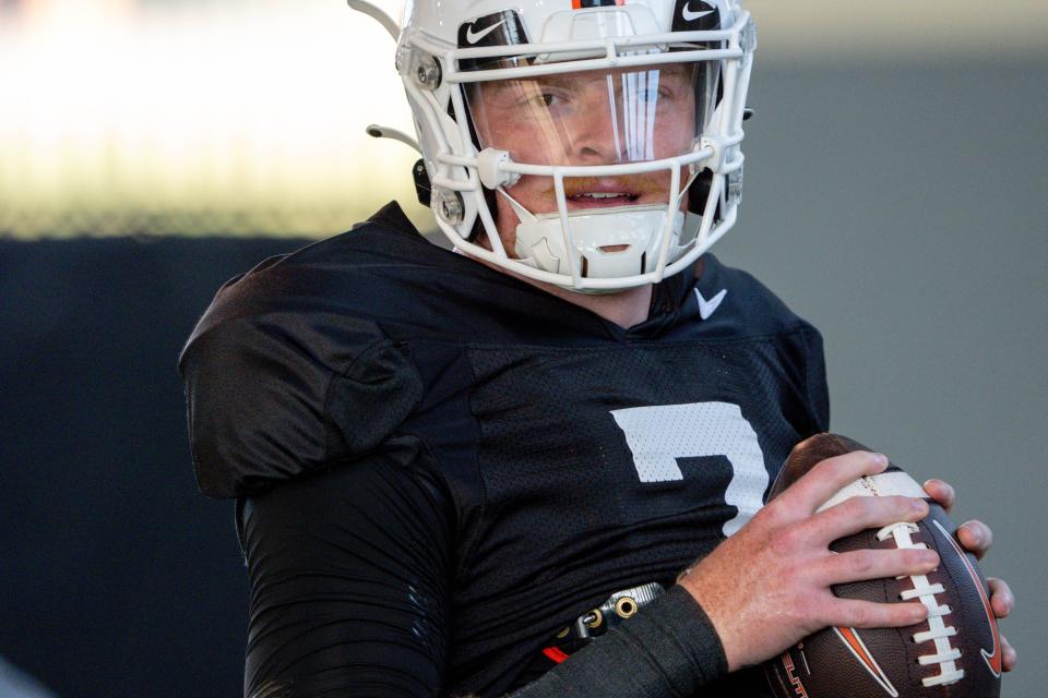 Alan Bowman (7) warms up during an Oklahoma State football practice in Stillwater, Okla., on Saturday, Aug. 3, 2024.