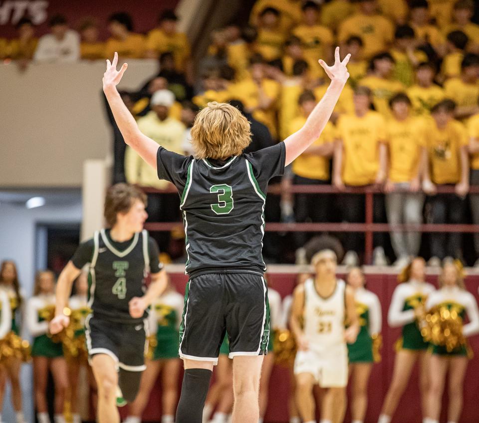 Trinity guard Avery Frasher gestures to the St. Xavier student section Friday night.