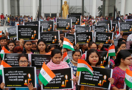 Students hold placards during a vigil to pay tribute to Central Reserve Police Force (CRPF) personnel who were killed after a suicide bomber rammed a car into a bus in south Kashmir on Thursday, in Agartala, India February 16, 2019. The placards read "Tribute to brave sons of mother India martyred in Kashmir". REUTERS/Jayanta Dey