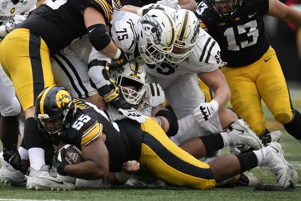 Iowa defensive lineman Jeremiah Pittman (55) recovers a fumble during the second half of an NCAA college football game against Western Michigan, Saturday, Sept. 16, 2023, in Iowa City, Iowa. Iowa won 41-10. (AP Photo/Charlie Neibergall)