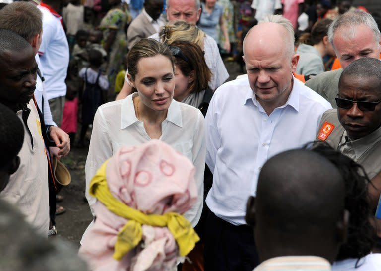 A photo released by the British Foreign Office shows Foreign Secretary William Hague (R) and UNHCR special envoy Angelina Jolie (L) talking to refugees on March 25 in DR Congo. Jolie has revealed that she underwent a double mastectomy to reduce her high risk of breast cancer, saying she is speaking out to encourage women to address threats to their health