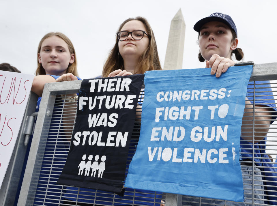 Participants hold signs saying 