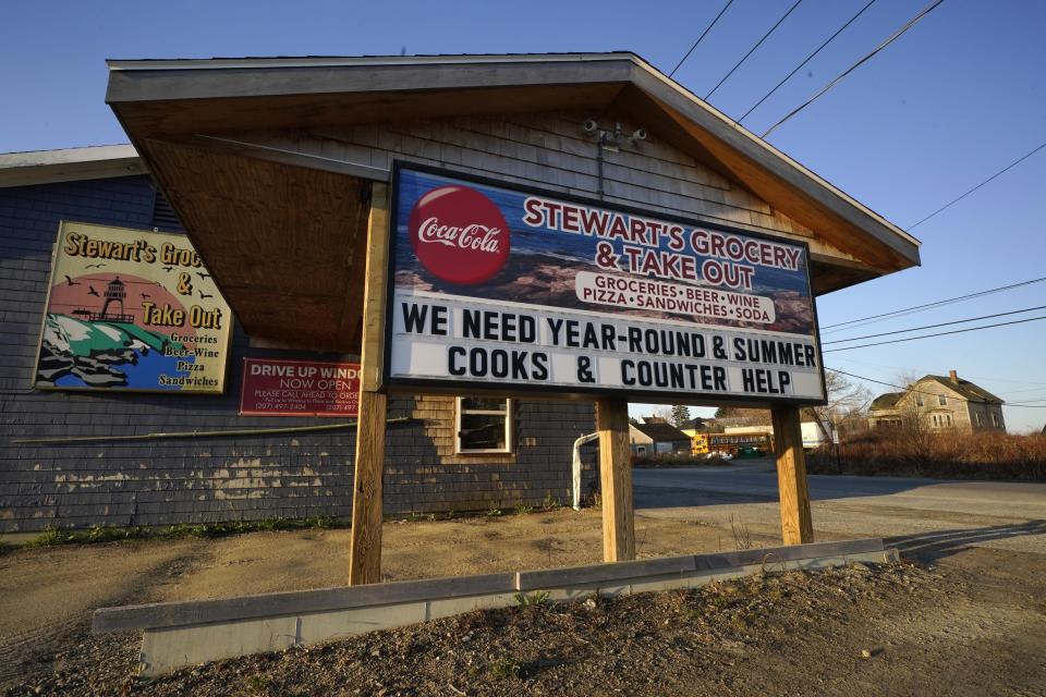 A sign advertises jobs at a small grocery store, Friday, April 28, 2023, in Jonesport, Maine. Supporters of a proposed patriotic-themed park say the venture would bring much-needed jobs to the local economy. (AP Photo/Robert F. Bukaty)