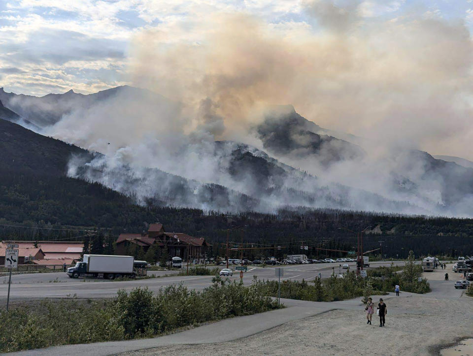 This photo provided by the National Park Service shows a wildfire burning about a mile north of Denali National Park and Preserve, Alaska, on June 30, 2024, as seen from a tourist area outside the park that's home to hotels, gift shops and restaurants. The fire prompted the national park into a temporary closure Monday. (National Park Service via AP)