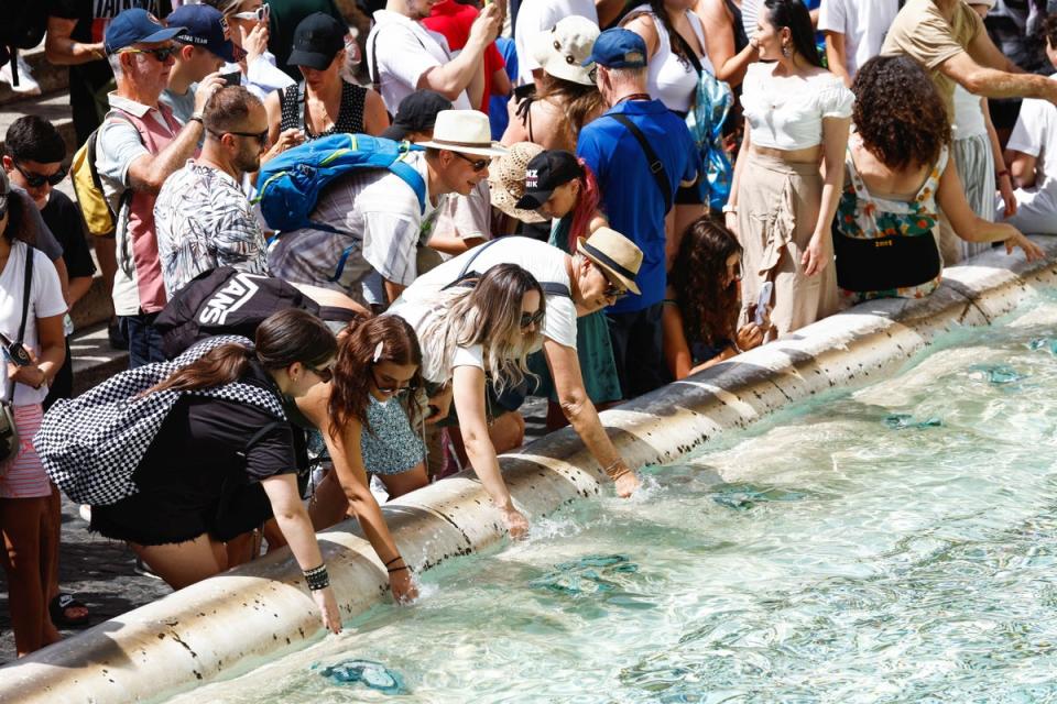 People cool themselves at the Trevi Fountain during a heatwave across Italy as temperatures are expected to cool off in Rome, Italy (REUTERS)