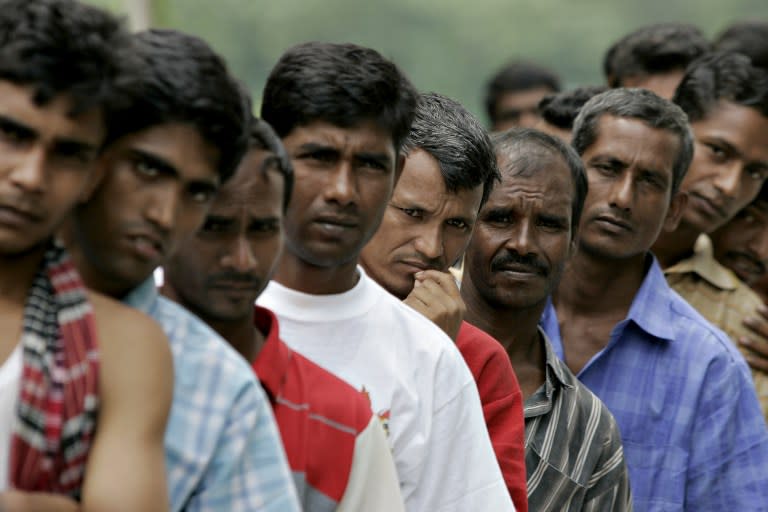 In this file photo, Bangladeshi migrant workers are seen queueing up outside the Bangladeshi High Commission in Kuala Lumpur. — AFP file pic