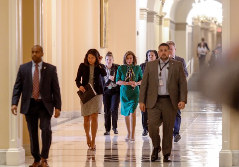House Speaker Nancy Pelosi walks with staff members on Capitol Hill in Washioington