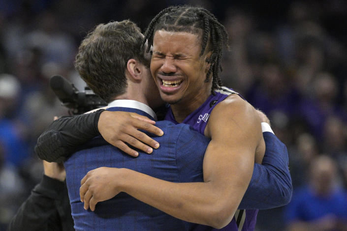 Furman guard Mike Bothwell, right, gets emotional after their win against Virginia in a first-round college basketball game in the NCAA Tournament, Thursday, March 16, 2023, in Orlando, Fla. Furman beat Virginia 68-67. (AP Photo/Phelan M. Ebenhack)