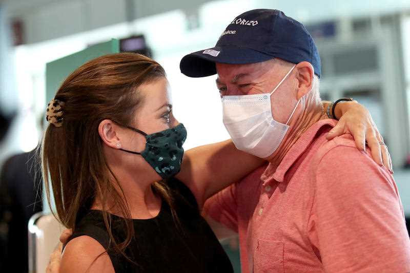 Rebecca Underhill hugs her father Paul Gimpel after she arrived from Sydney to be reunited with family at Brisbane Domestic Airport, Brisbane.