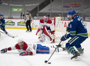 Montreal Canadiens goaltender Carey Price (31) looks on as Vancouver Canucks centre J.T. Miller (9) tries to get a shot past Montreal Canadiens defenseman Brett Kulak (77) during the second period NHL action in Vancouver, Monday, March 8, 2021. (Jonathan Hayward/The Canadian Press via AP)