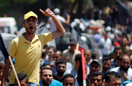 Palestinian demonstrator gestures as he chants slogans during a protest against Bahrain's workshop for U.S. Middle East peace plan, in Gaza City