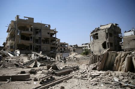 A man walks at a site hit by an airstrike in the rebel held Douma neighbourhood of Damascus, Syria August 22, 2016. REUTERS/Bassam Khabieh