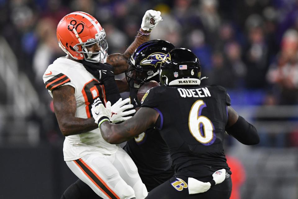 Cleveland Browns wide receiver Jarvis Landry (80) has the ball stripped by Baltimore Ravens safety Chuck Clark and linebacker Patrick Queen (6)during the second quarter of an NFL football game, Sunday, Nov. 28, 2021, in Baltimore. (AP Photo/Terrance Williams)