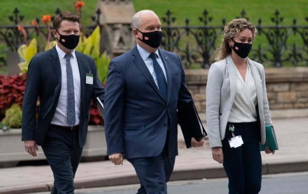 Conservative Leader Erin O'Toole walks with his chief of staff Tausha Michaud, right, and campaign manager Fred DeLorey, left, in Ottawa.