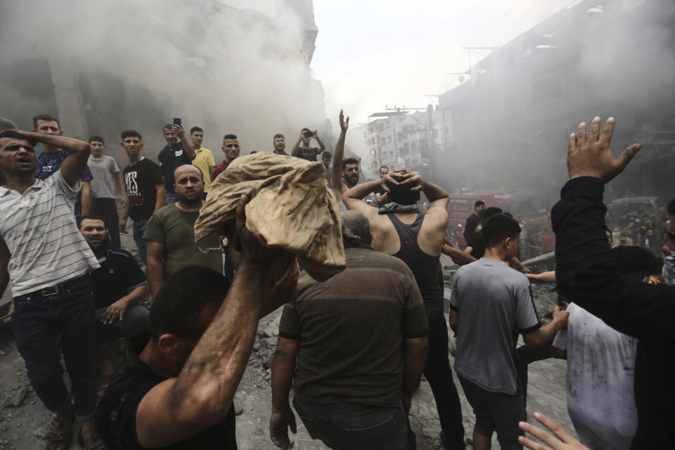 Palestinians react after removing a dead body from the rubble of a building after an Israeli airstrike in Jebaliya refugee camp, Gaza Strip, Monday, Oct. 9, 2023. (AP Photo/Ramez Mahmoud )