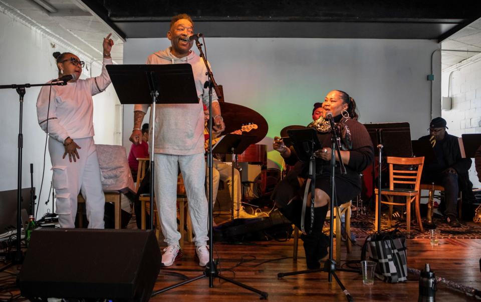 Lynn Marie, left, Rob Carter, middle, Chelly K, and the rest of the Detroit City Jazz Orchestra Plus members rehearse on stage inside Trinosophes in Detroit on Thursday, March. 9, 2023. 