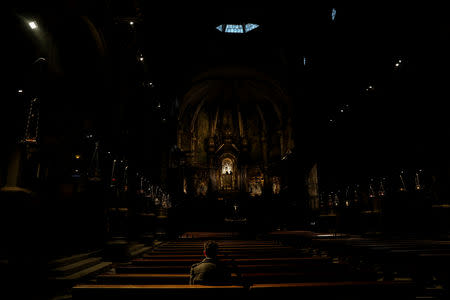 Miguel Hurtado, 36, who says he was sexually abused at the age of 16 by a Benedictine monk from Montserrat Abbey in Catalonia, poses for a portrait inside the church of the abbey in Montserrat, outside Barcelona, Spain, February 2, 2019. REUTERS/Susana Vera