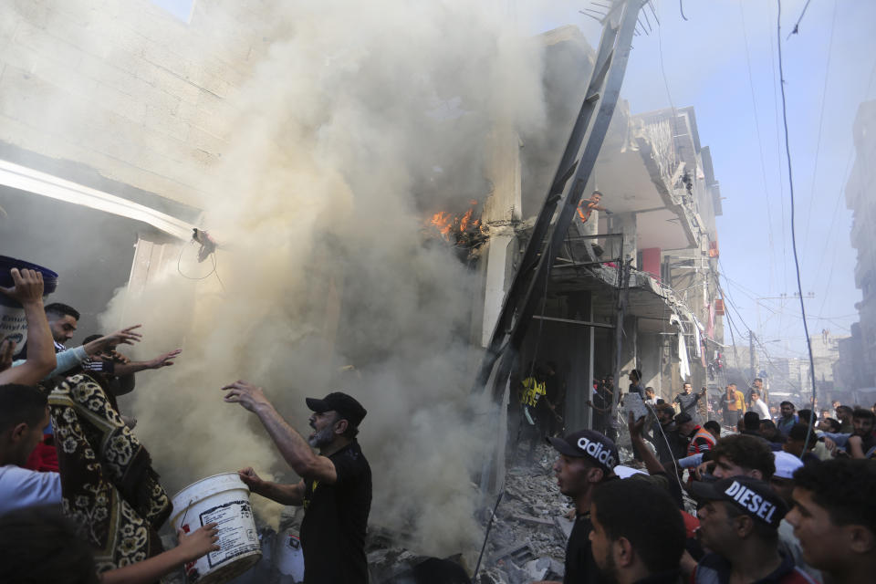 Palestinians look for survivors after an Israeli strike on Rafah, Gaza Strip, Friday, Nov. 17, 2023. (AP Photo/Hatem Ali)