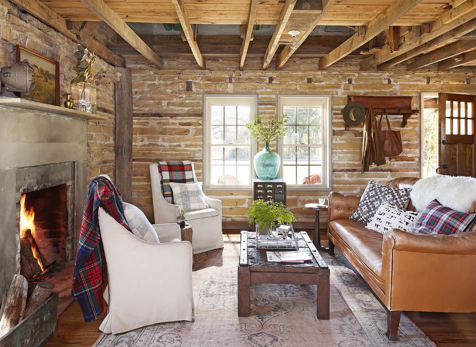 living room of a tennessee cabin with brick walls and low ceiling with wood beams