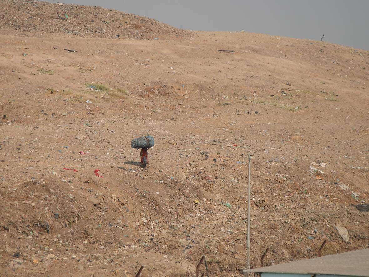 Deonar, in east Mumbai, is some 18 storeys high and has been a waste deposit site for nearly a century, harbouring 16 million tonnes of trash which hundreds of pickers sift through every day to find bits of plastics and metal that they can sell.  (Salimah Shivji/CBC - image credit)