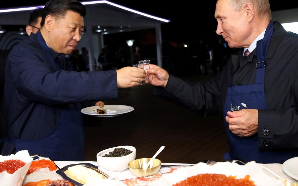 Xi Jinping and Vladimir Putin toast on the sidelines of the eastern economic forum in Vladivostok - REUTERS