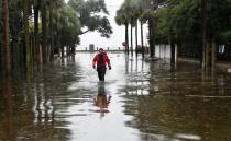 A firefighter walks on a flooded street in downtown Charleston, South Carolina on October 4, 2015