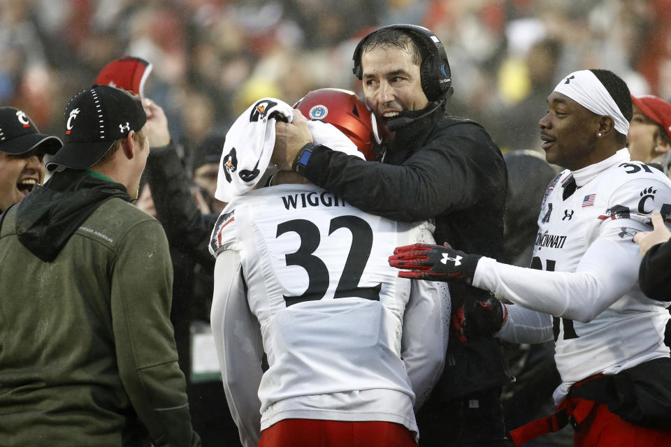 Cincinnati Bearcats coach Luke Fickell hugs safety James Wiggins (32) after Wiggins intercepted a pass during the Military Bowl on Dec. 31, 2018. (Getty)