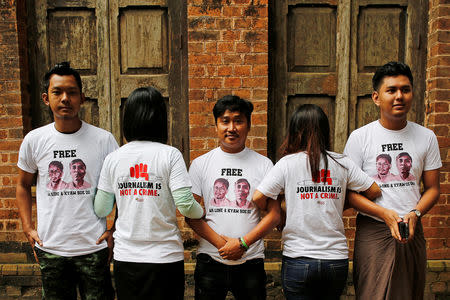 Friends of detained Reuters journalists Wa Lone and Kyaw Soe Oo stand at Insein court in Yangon, Myanmar August 27, 2018. REUTERS/Ann Wang