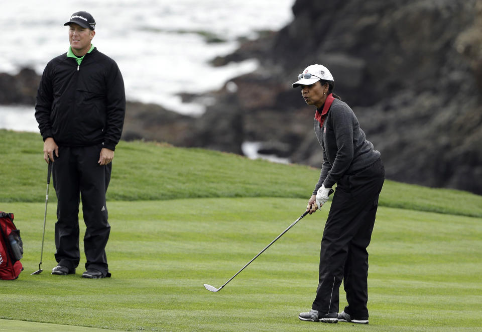 Former United States Secretary of State Condoleezza Rice, right, watches her ball roll up to the eighth green of the Pebble Beach Golf Links as playing partner D.A. Points, left, looks on during the second round of the AT&T Pebble Beach Pro-Am golf tournament on Friday, Feb. 7, 2014, in Pebble Beach, Calif. (AP Photo/Eric Risberg)